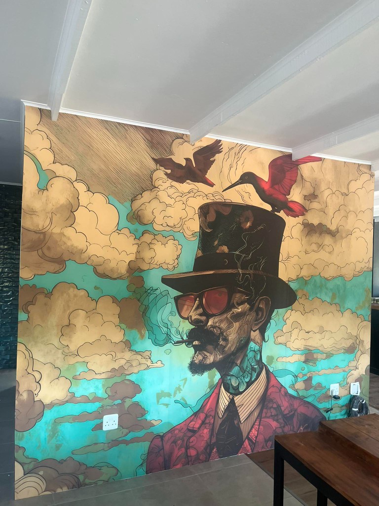 Large custom illustrated wallpaper mural with portrait artwork on a full wall