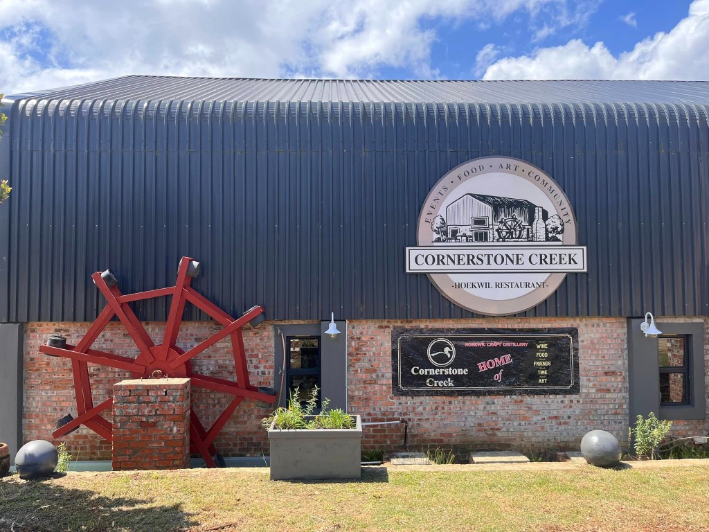 Exterior blade signage on a commercial brick fascia
