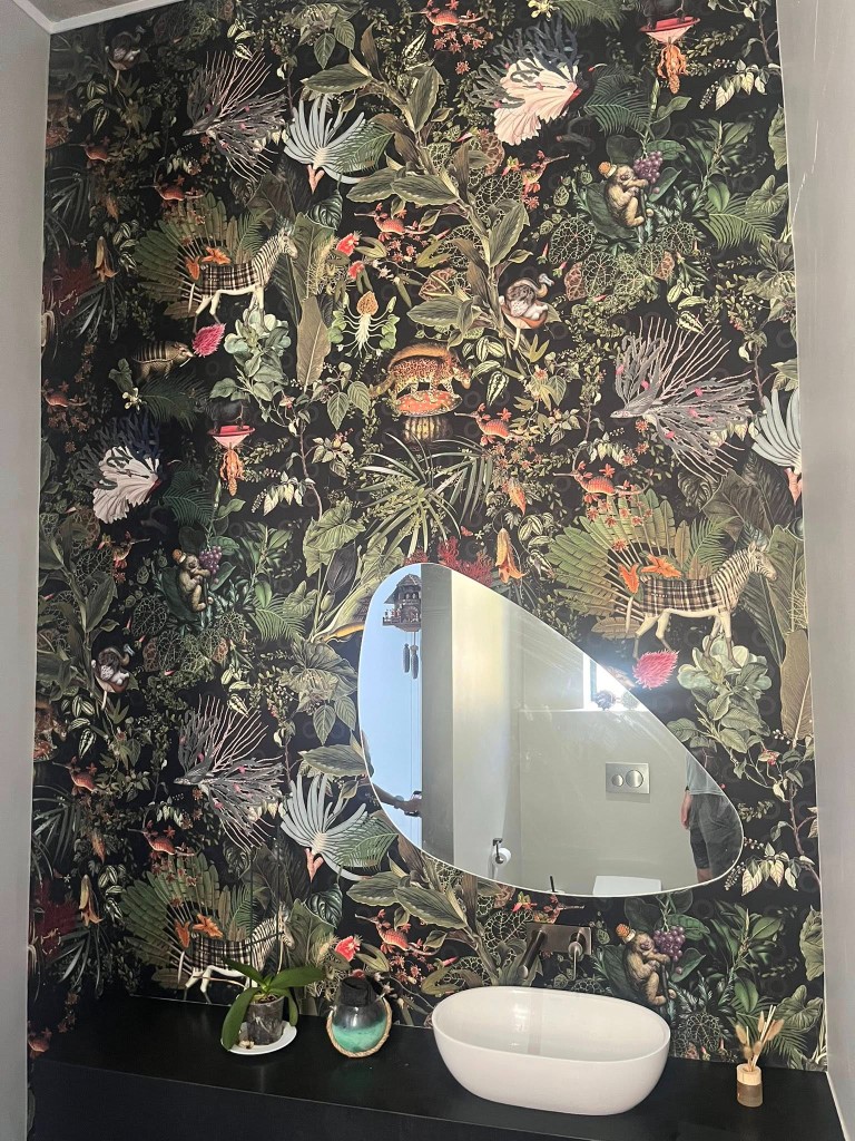 Remedial botanical wallpaper install in a compact wet-area room